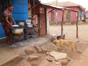 woman by cooking pot at eatery in Arusha region, Tanzania